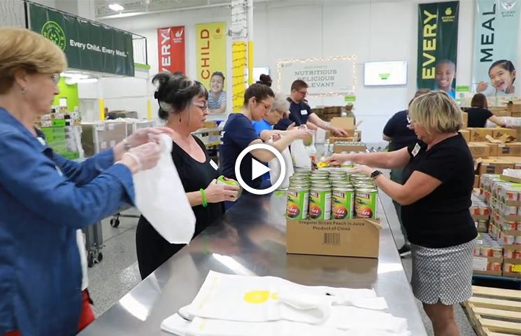  Volunteers putting canned food into plastic bags