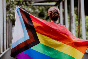 Person holding pride flag 