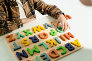  Close up of a boy playing with an ABC puzzle