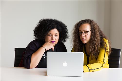 Two women of color looking at computer