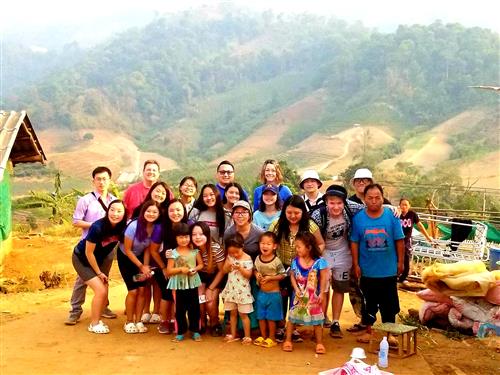 Group photo of Washington and Harding students and staff with a few local Hmong villagers in the Chiang Mai area. 