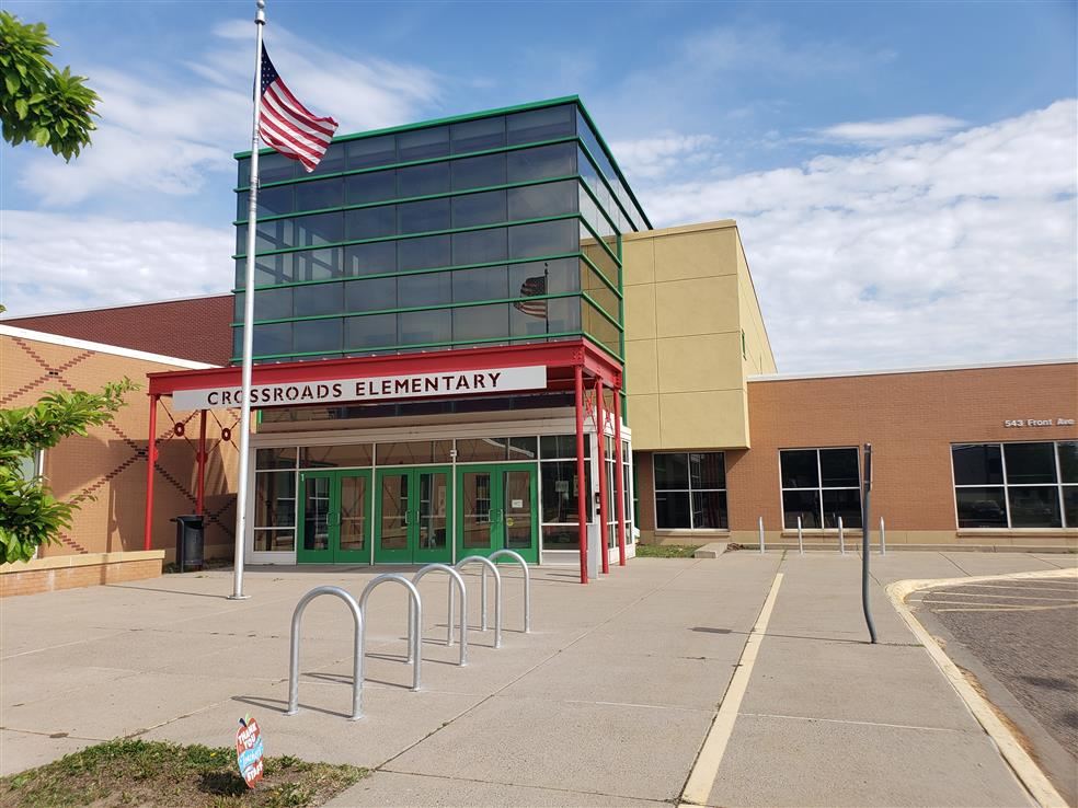 Crossroads Elementary - Photo of front entrance, bike racks, and flag pole.