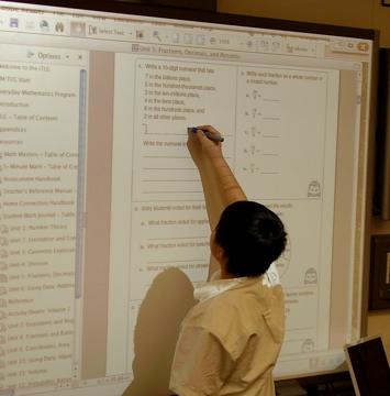 A student uses a Smart Boards during a math lesson.