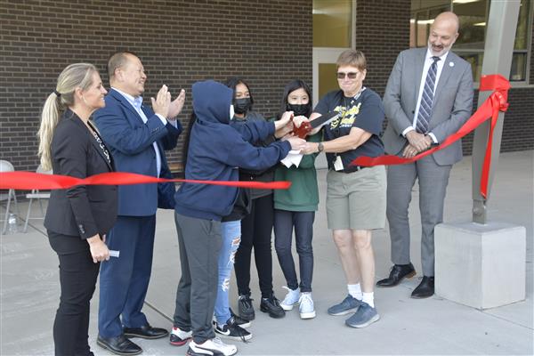 The ribbon cutting is led by Carol Sellars, veteran Frost Lake Elementary physical education teacher, and students